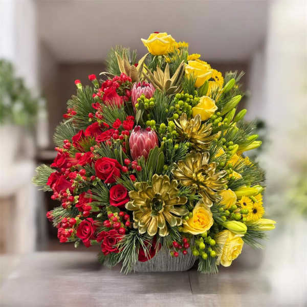 Red and yellow floral arrangement in a gray container