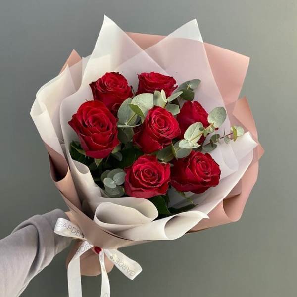 Bouquet of red roses wrapped in white and blush paper