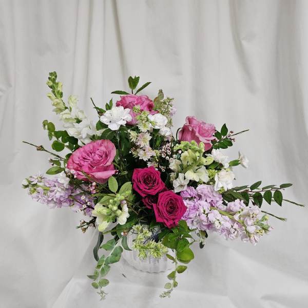 Pink and white mixed flower arrangement in a white vase