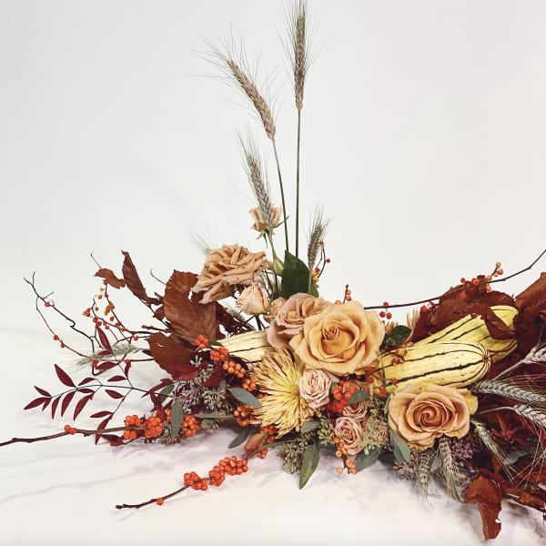 Autumn floral arrangement with peach roses and wheat stalks
