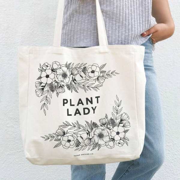 Canvas tote bag with floral line art and the words "PLANT LADY"