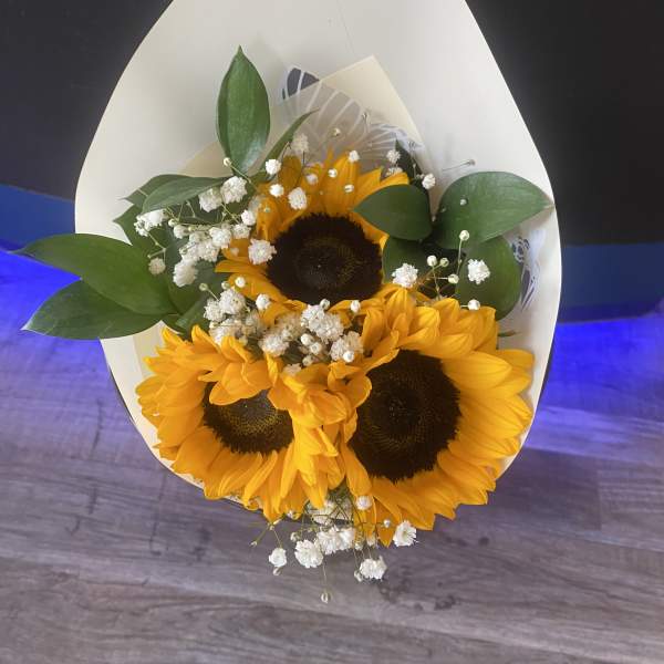 Bouquet of sunflowers with white baby's breath in white wrap