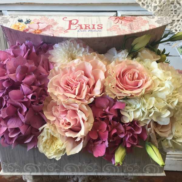 Pink and cream roses with purple hydrangeas in a decorative box