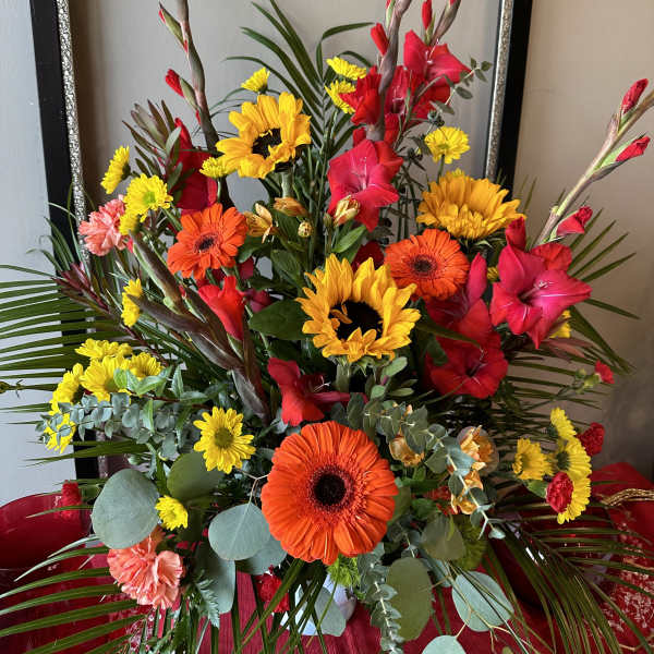 Bright mixed bouquet with sunflowers, gerbera daisies, and red gladiolus