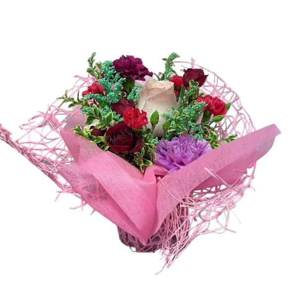 Pink bouquet with red and purple flowers wrapped in pink paper