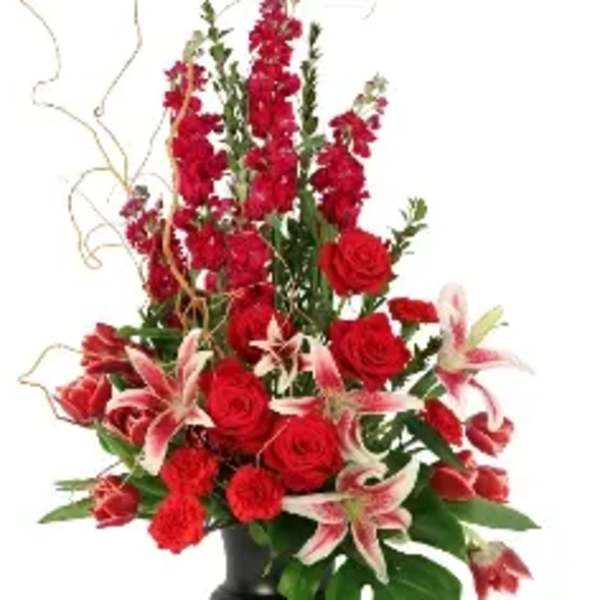 Red roses and lilies in a black vase