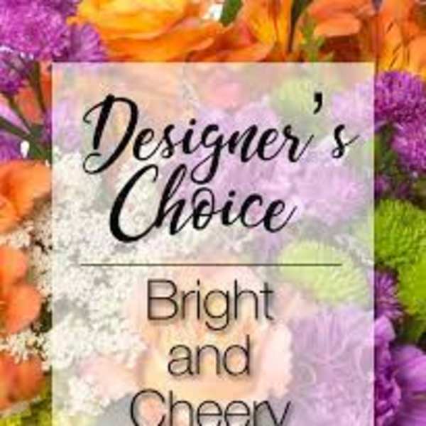 Bright mixed flowers behind a "Designer’s Choice" sign