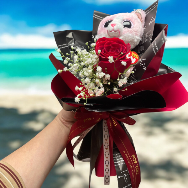 Red rose bouquet with baby's breath and a plush cat topper