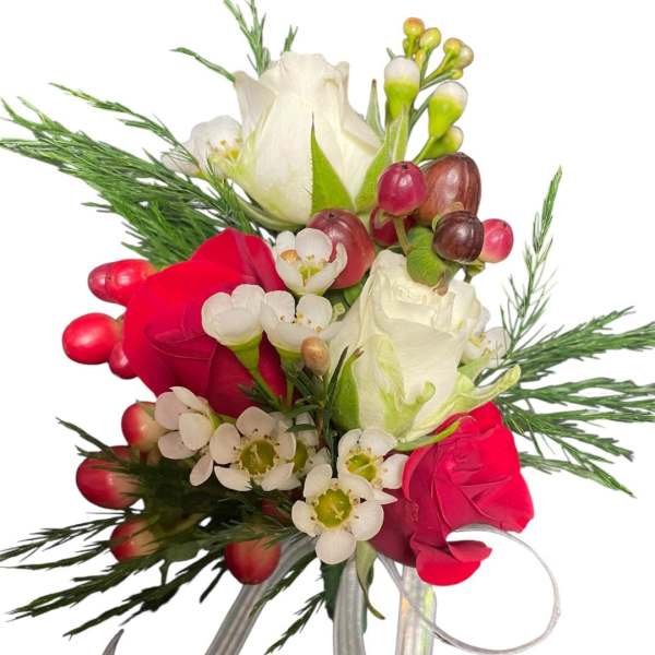 Bouquet of red and white roses with small white blossoms and greenery