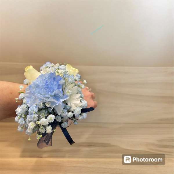 Small hand-tied bouquet of blue and white flowers with ribbon
