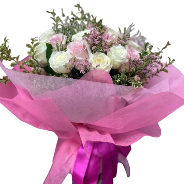 Pink and white rose bouquet wrapped in bright pink paper