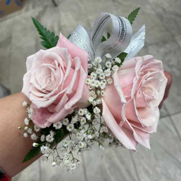 Pink rose corsage with baby's breath and ribbon
