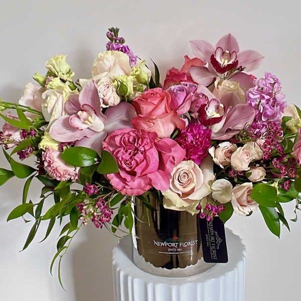 Pink and blush floral arrangement in a metallic vase