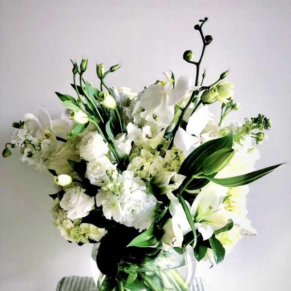 White floral bouquet in a clear glass vase