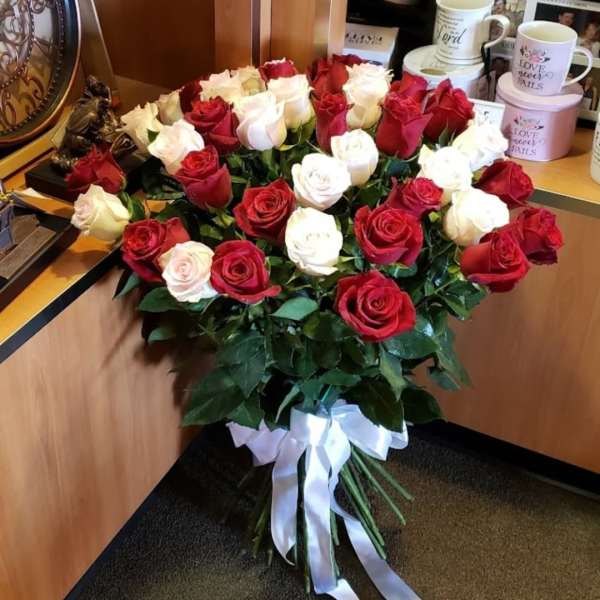 Bouquet of red and white roses tied with a white ribbon