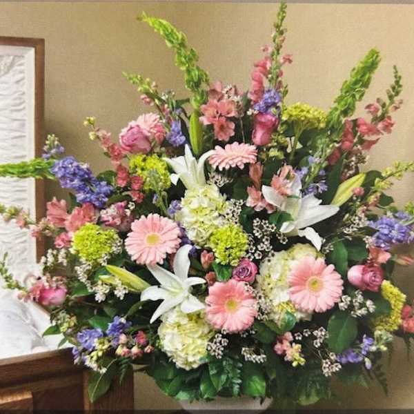 Large mixed floral arrangement with pink, white, purple, and green blooms