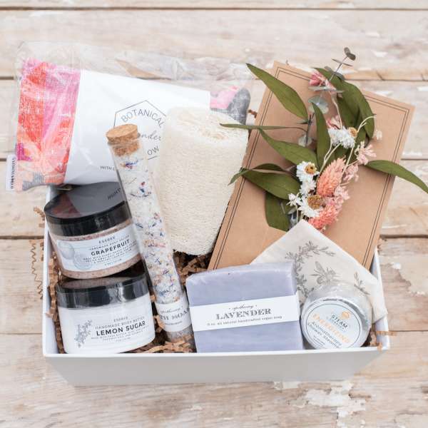Gift box with bath products and a small dried floral card