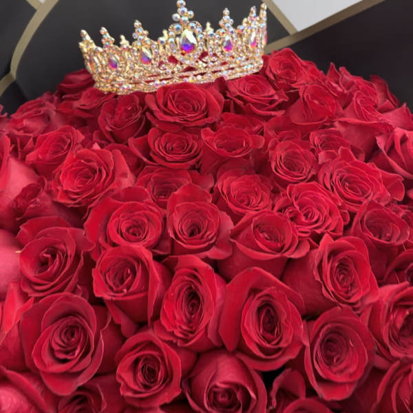 Bouquet of red roses with a jeweled crown topper