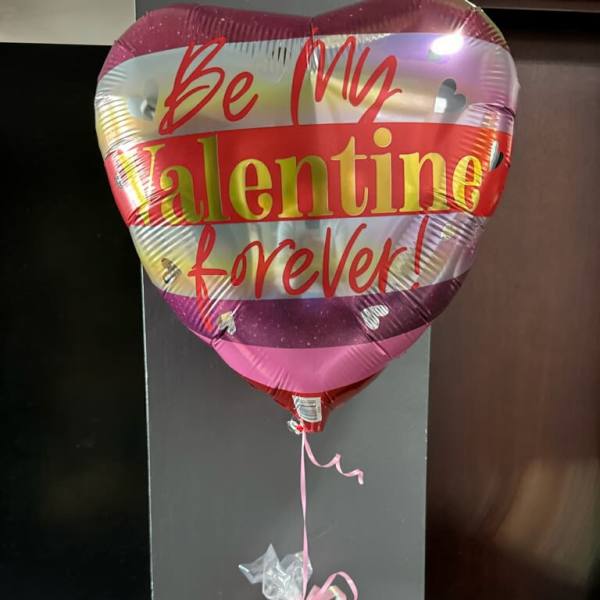 Heart-shaped Valentine balloon with a candy gift bundle below