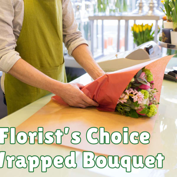 Florist wrapping a mixed bouquet in pink paper