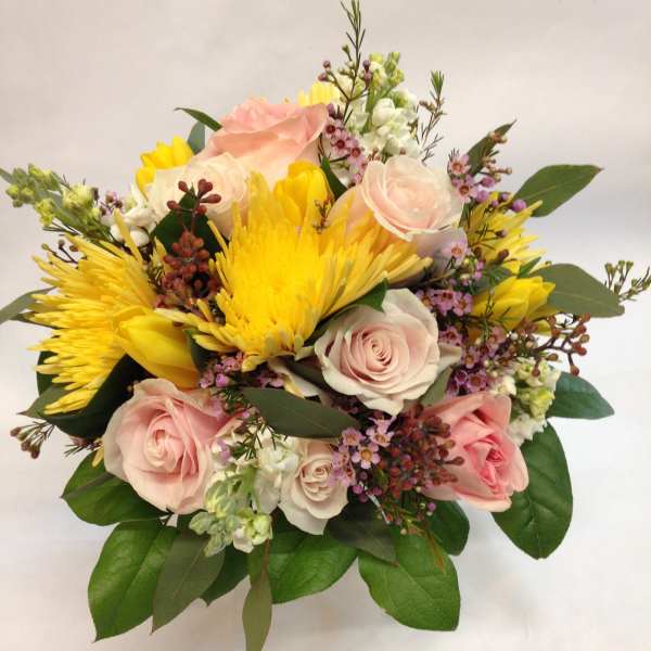 Bouquet of pink roses and yellow chrysanthemums with greenery