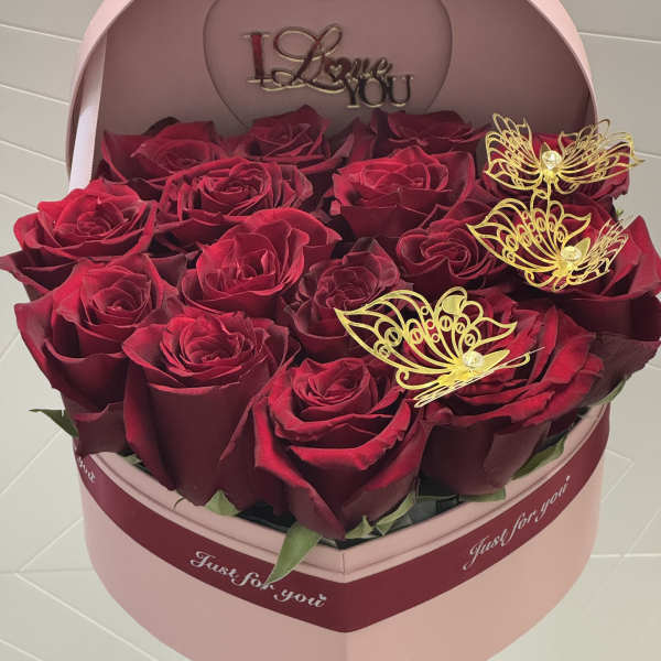 Heart-shaped box of red roses with gold butterfly decorations