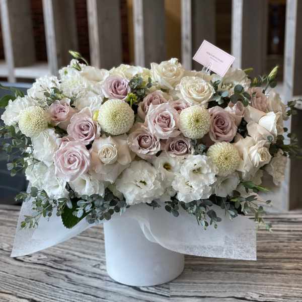 Pastel rose and white flower arrangement in a white box