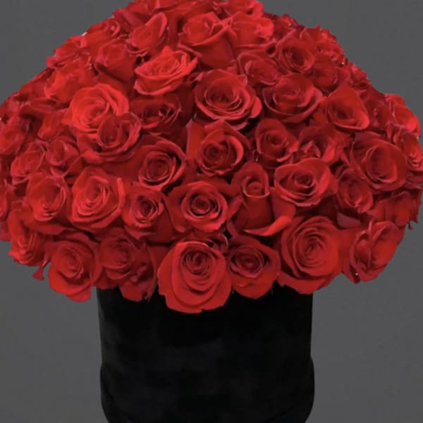 Large bouquet of red roses in a black box