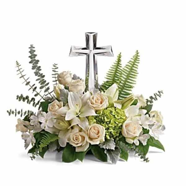 White floral arrangement with a silver cross centerpiece