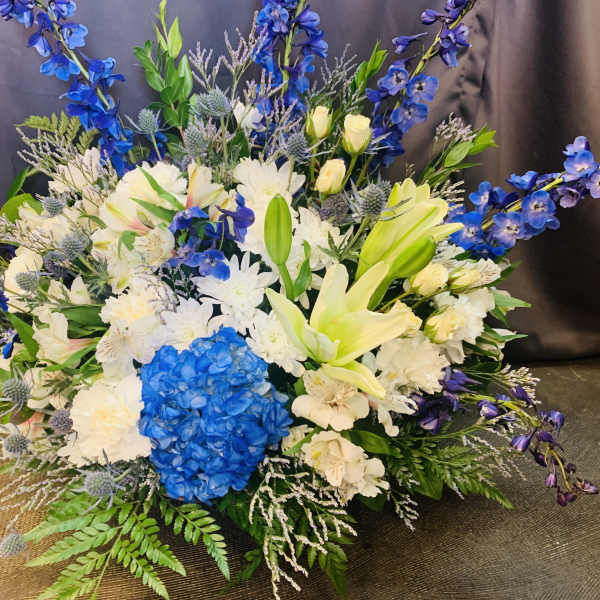 Large bouquet of white and blue flowers with lilies and hydrangea