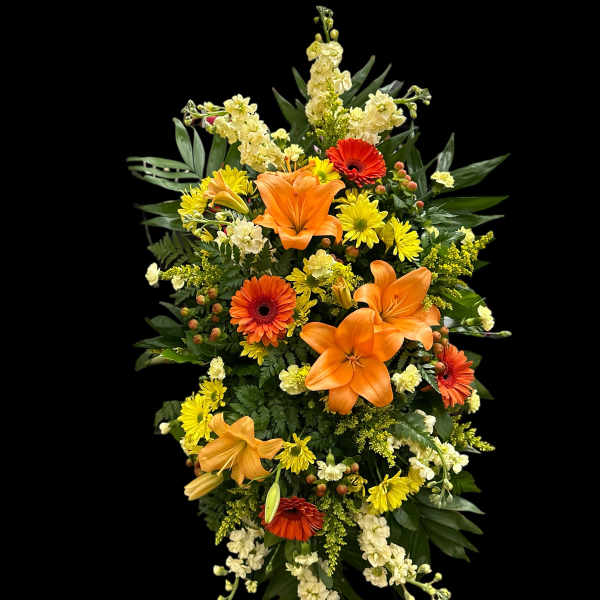 Tall standing spray with orange lilies and yellow and red flowers