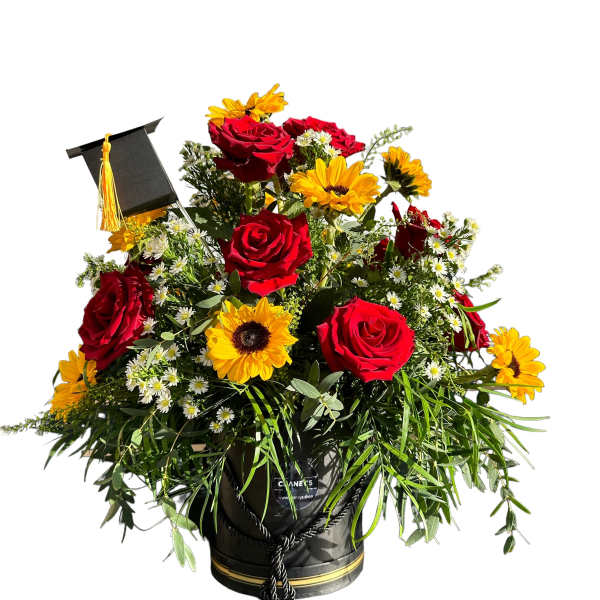 Red roses and yellow sunflowers in a black graduation cap container