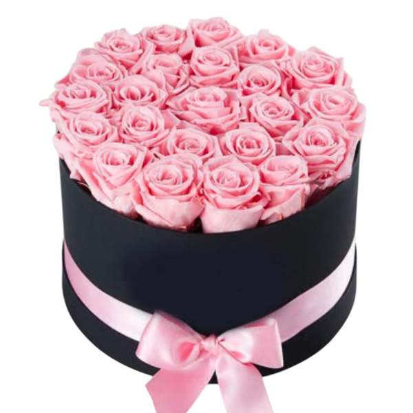 Pink roses arranged in a black round box with a pink ribbon bow