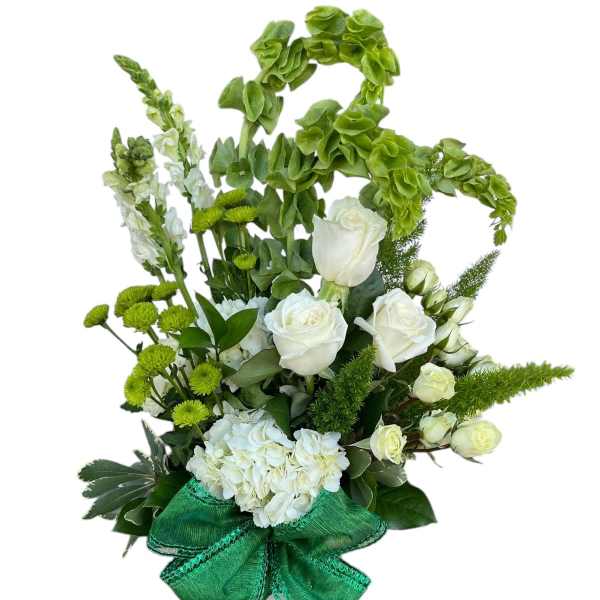 White roses and green flowers in a vase with a large green bow