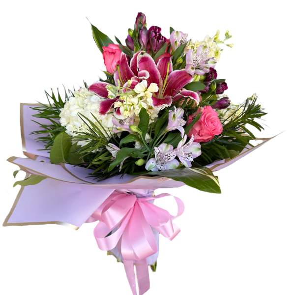 Pink and white mixed bouquet wrapped in lavender paper with a pink ribbon
