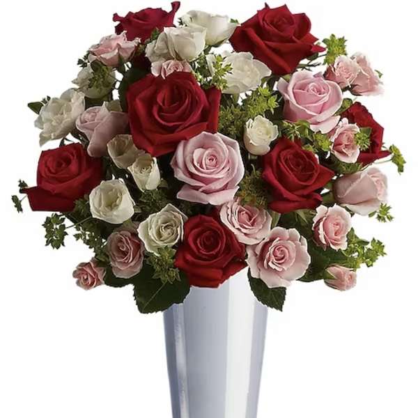 Bouquet of red, pink, and white roses in a tall silver vase