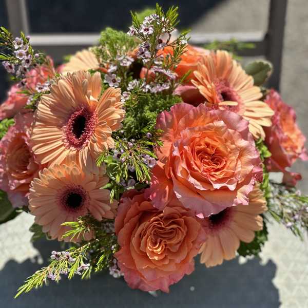 Bouquet of peach gerbera daisies and coral roses