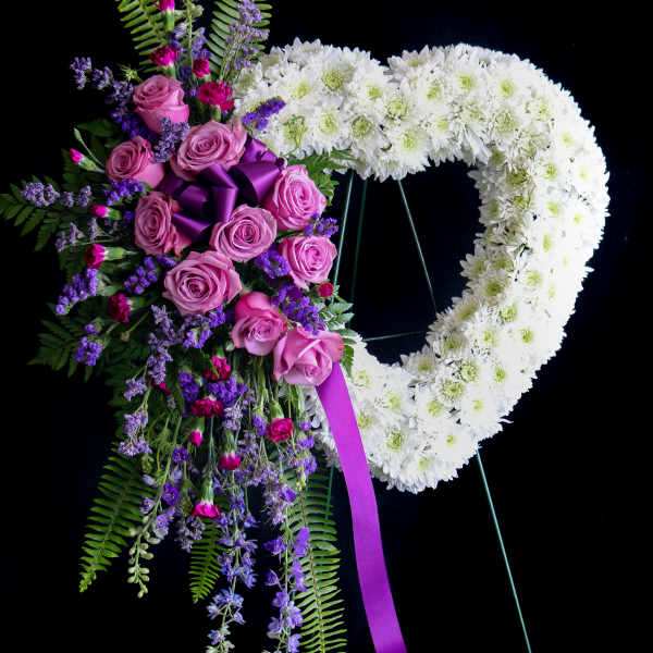 Heart-shaped floral wreath with pink roses and white chrysanthemums