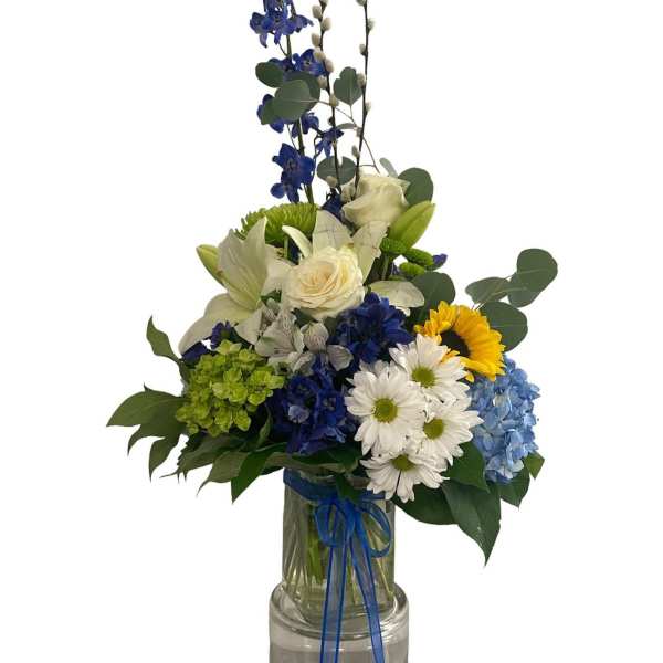 Blue and white floral arrangement in a glass vase with a ribbon