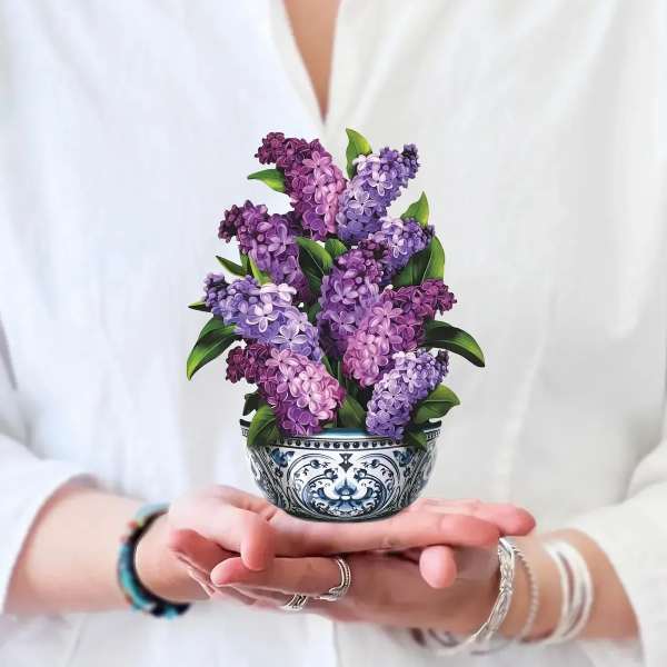 Purple lilac bouquet in a decorative ceramic bowl