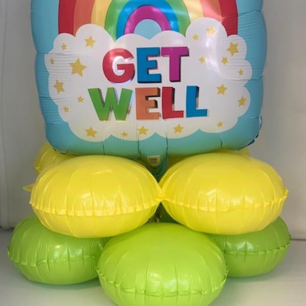 Rainbow "Get Well" balloon arrangement with yellow and green base balloons