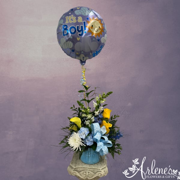Balloon-topped flower arrangement in a blue vase with yellow and blue blooms
