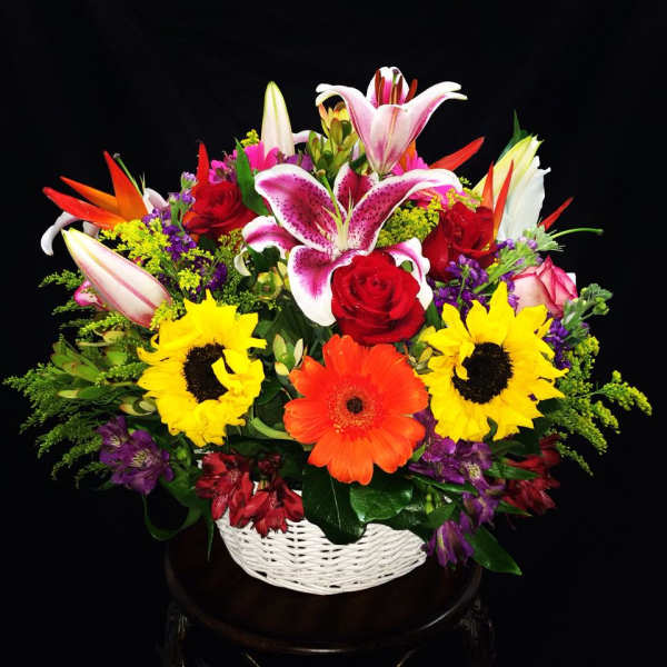 Colorful mixed flower basket with lilies, roses, sunflowers, and gerbera daisies