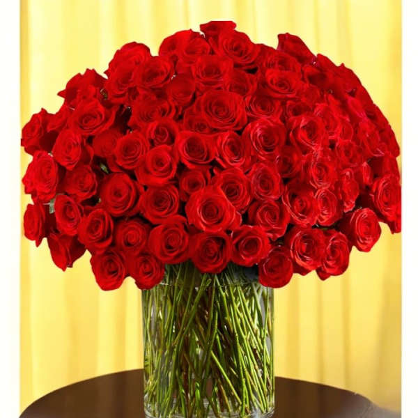 Large bouquet of red roses in a clear glass vase