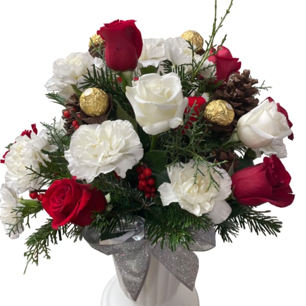Red and white roses with carnations in a white vase