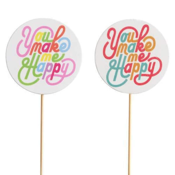 Two round cake toppers with colorful "You make me happy" text