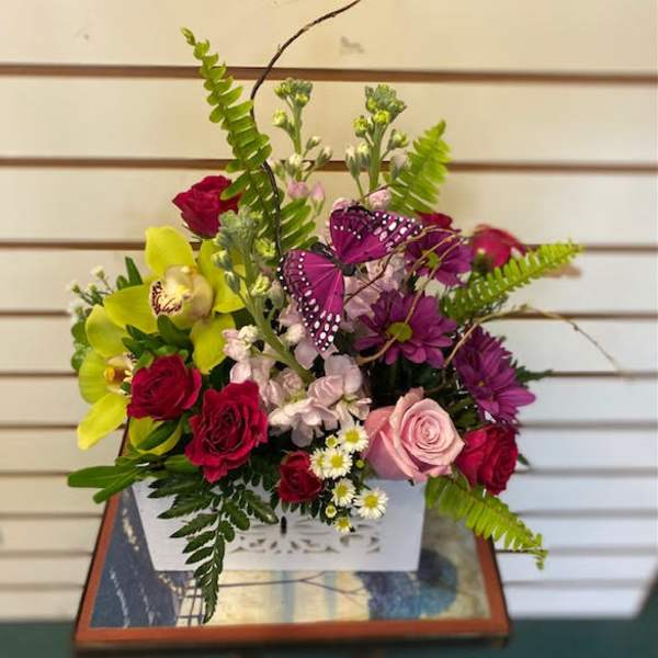 Mixed bouquet in a white box with roses, orchids, and purple butterflies