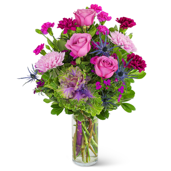 Pink roses and purple flowers in a clear glass vase