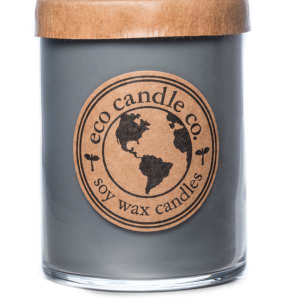 Gray candle in a glass jar with a wooden lid and round label