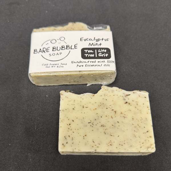 Two bars of eucalyptus mint soap, one wrapped and one unwrapped
